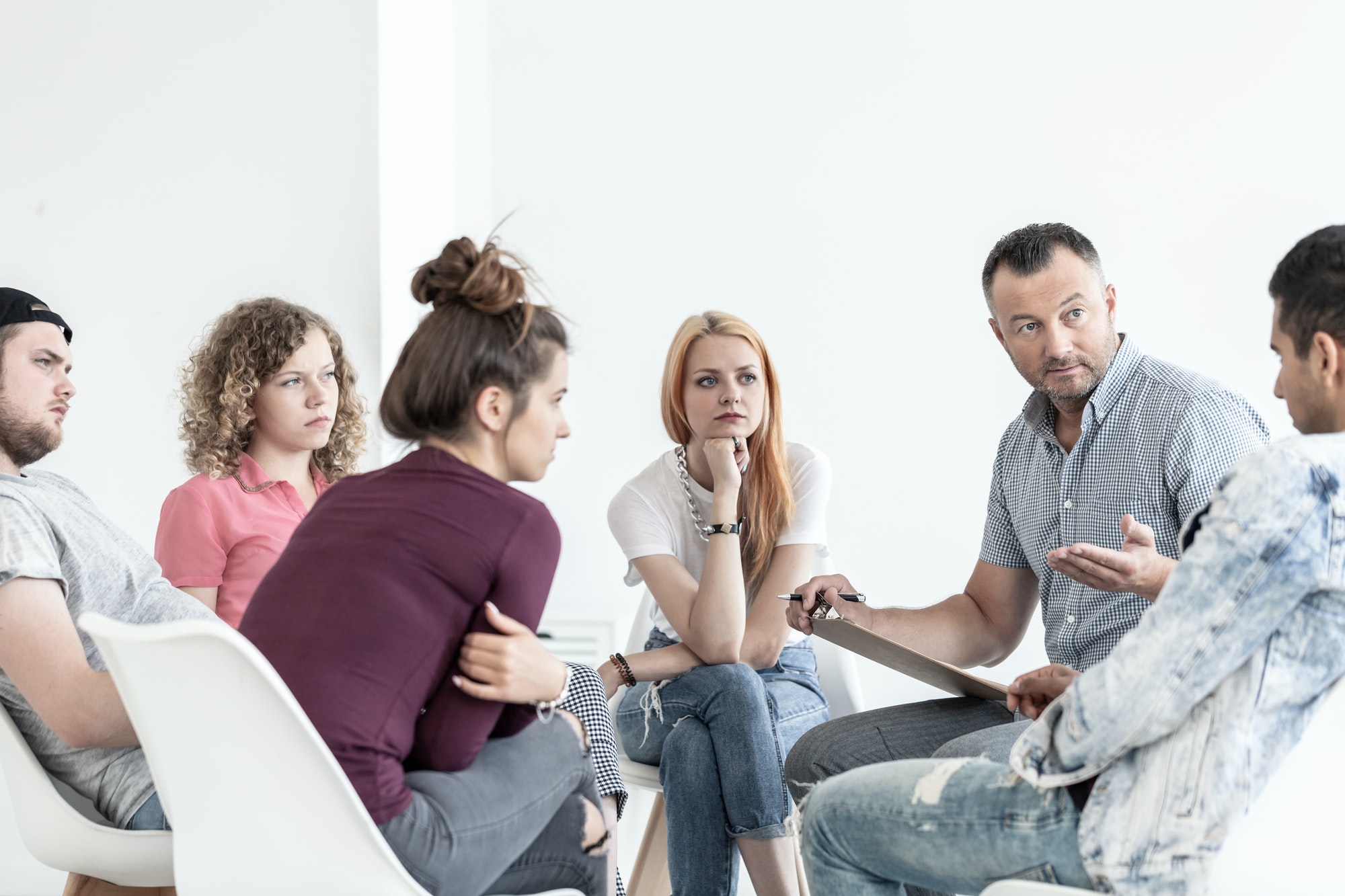 School counselor explaining anger management techniques to a gro