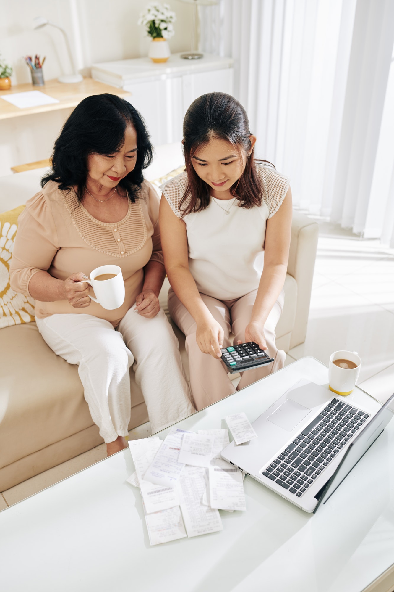 Woman helping mother with bookkeeping